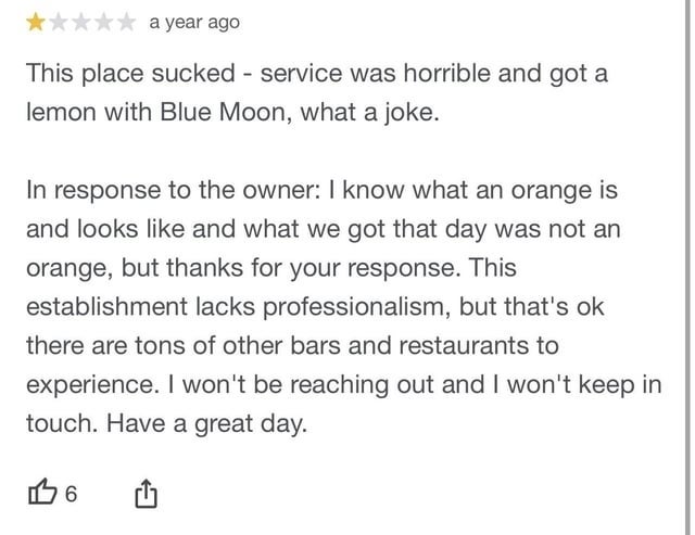 A text review expressing disappointment with service and experience, saying they got a lemon wedge with their Blue Moon beer, and argued with the owner because they know what an orange looks like