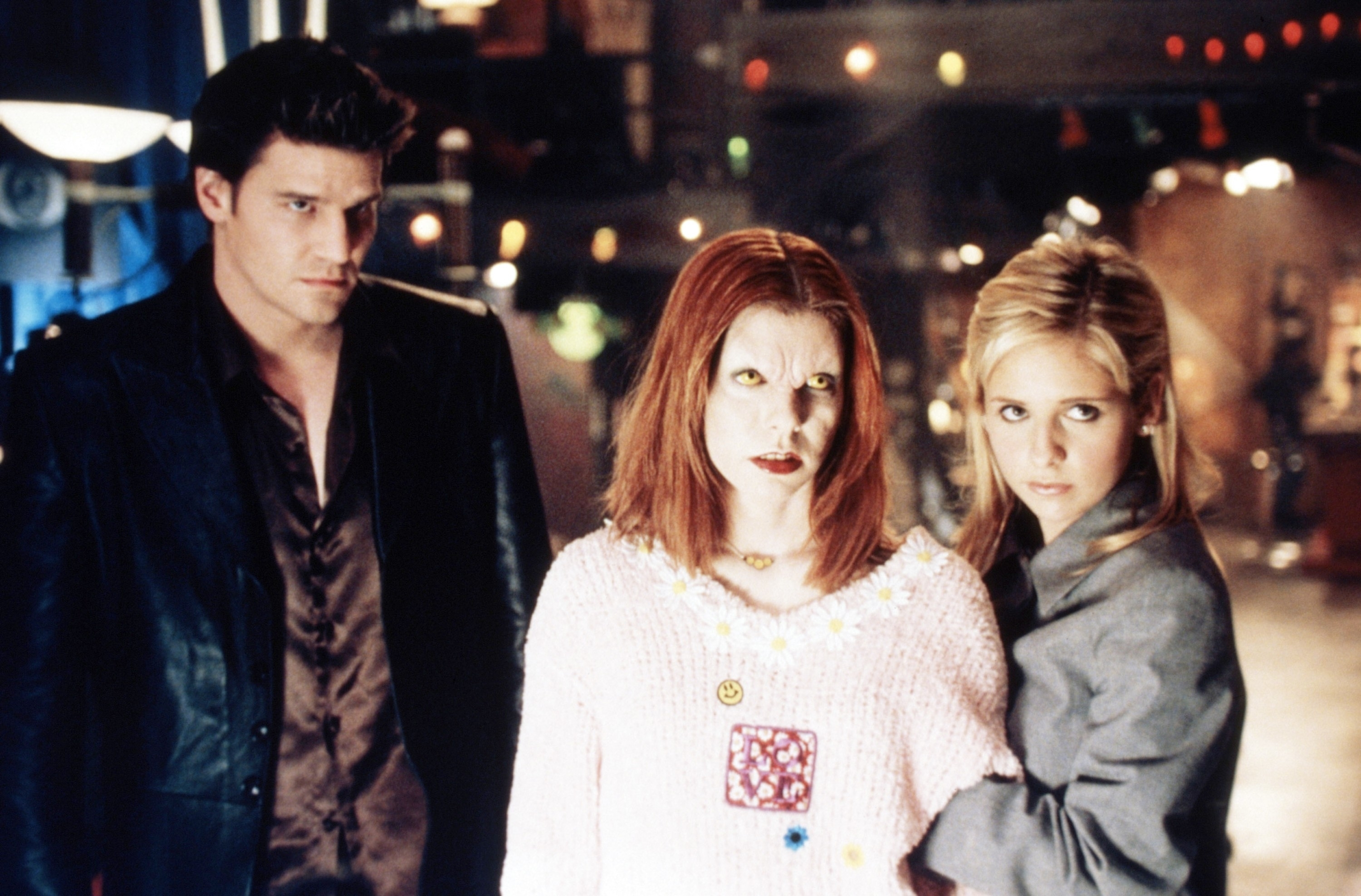 Three characters from Buffy the Vampire Slayer standing together; one male on the left, two females on the right