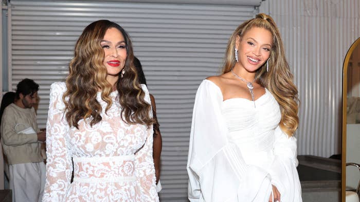Tina Knowles in a lace dress and Beyoncé in a white off-shoulder gown