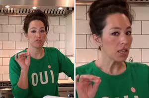Woman in green "oui" sweatshirt speaking and gesturing in a kitchen setting