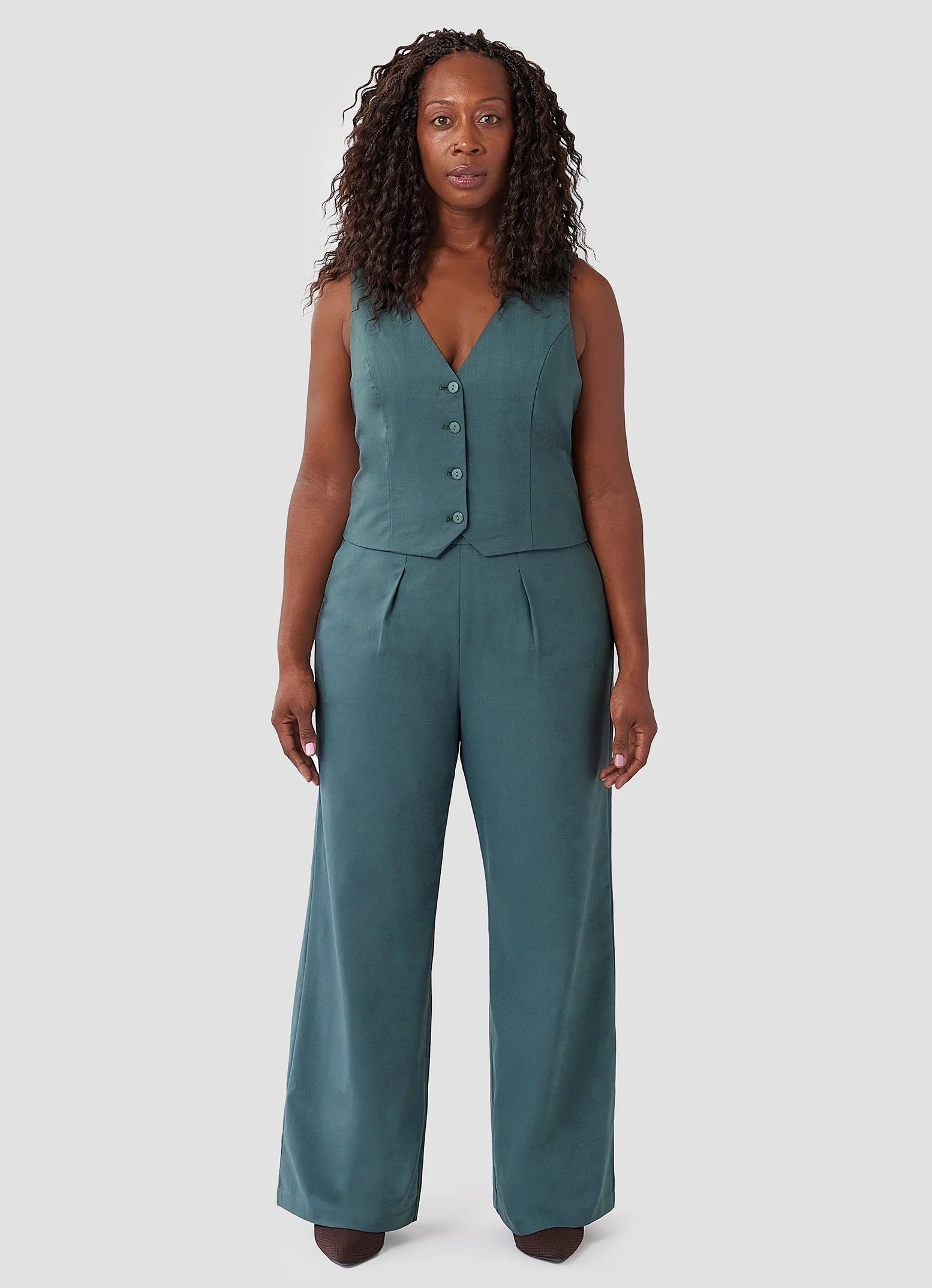 model in matching teal vest and wide-legged trouser set