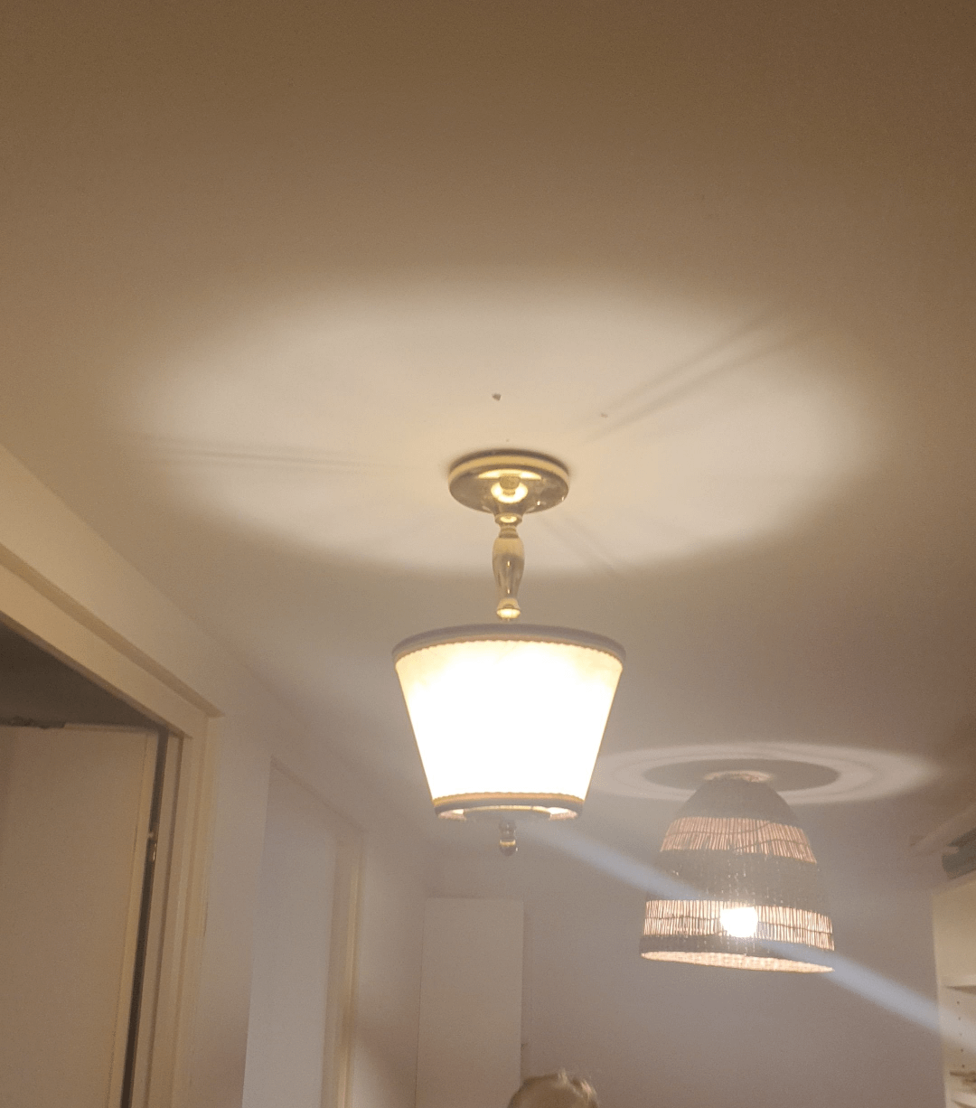 A table lamp upside down and being used as a chandelier