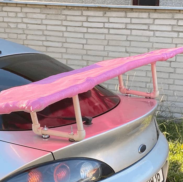 Car with a makeshift pink foam roof rack