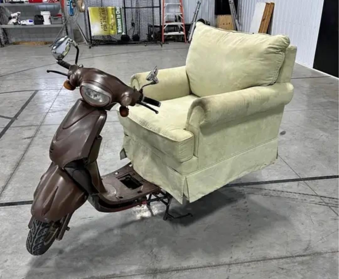 An armchair placed on a motor scooter