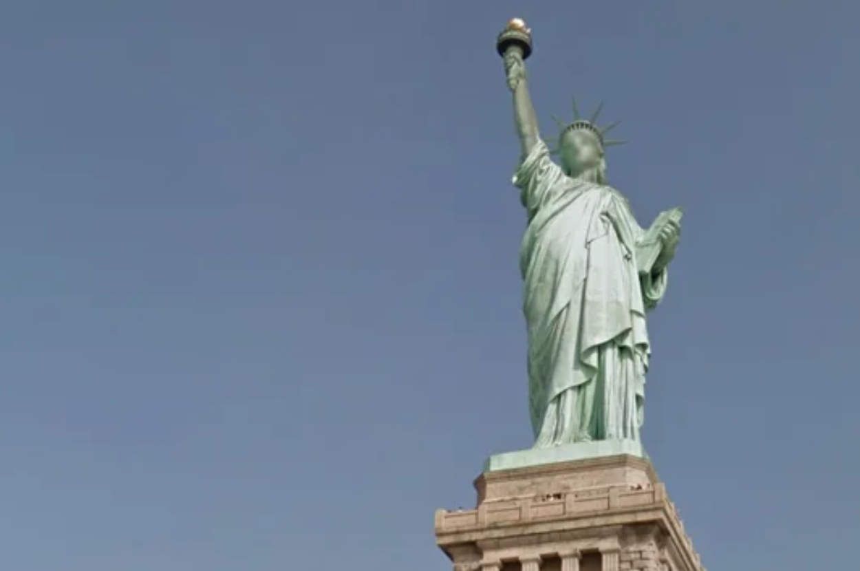 Statue of Liberty against the sky, holding a torch and tablet, symbolizing freedom