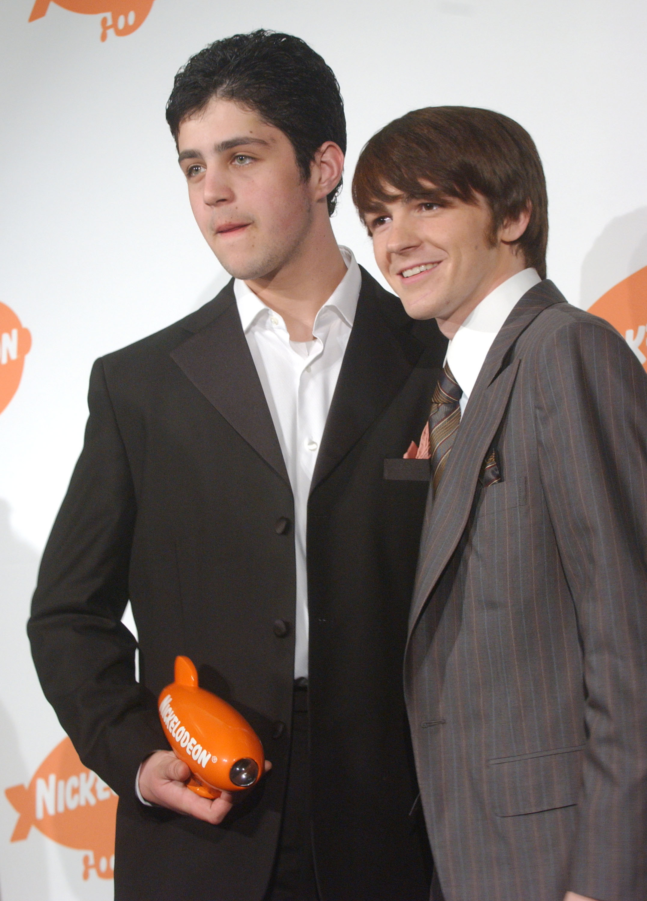 Drake and Josh on the red carpet, while Josh holds their Nickelodeon Award