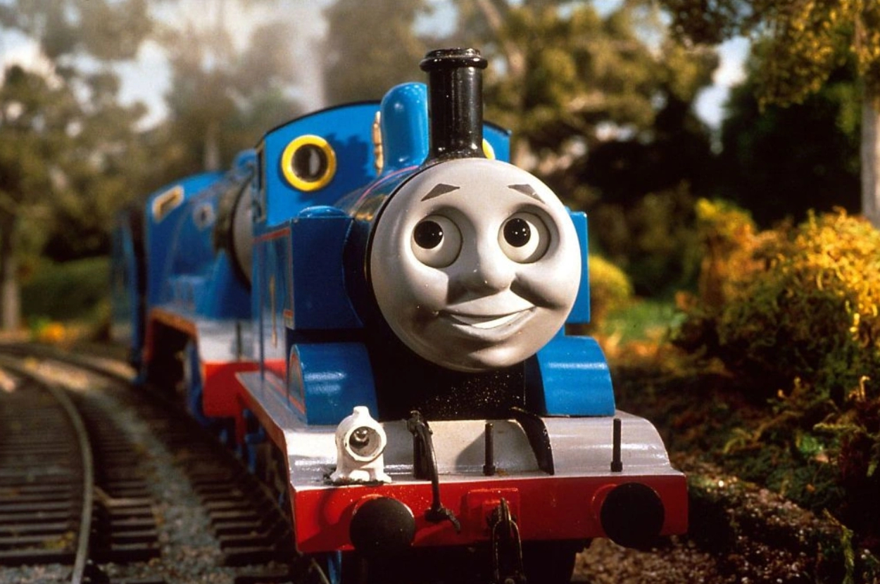 Toy model of Thomas the Tank Engine from the series on train tracks