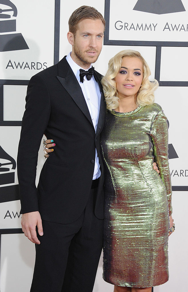 Calvin and Rita posing at the Grammy Awards, him in suit with bow tie and her in shimmery dress