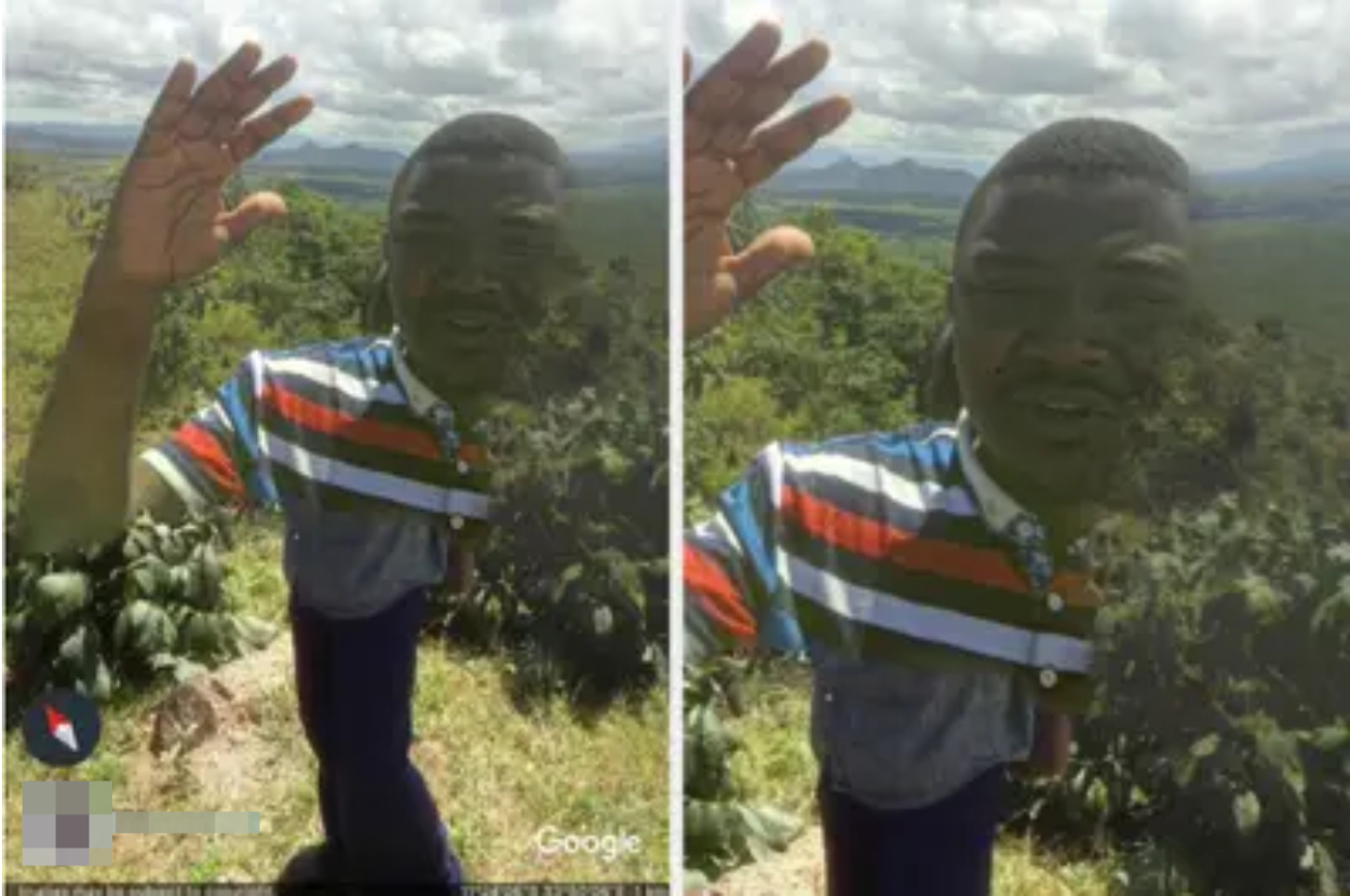 Man in a striped shirt waving at the camera, standing in a natural landscape with hills in the background