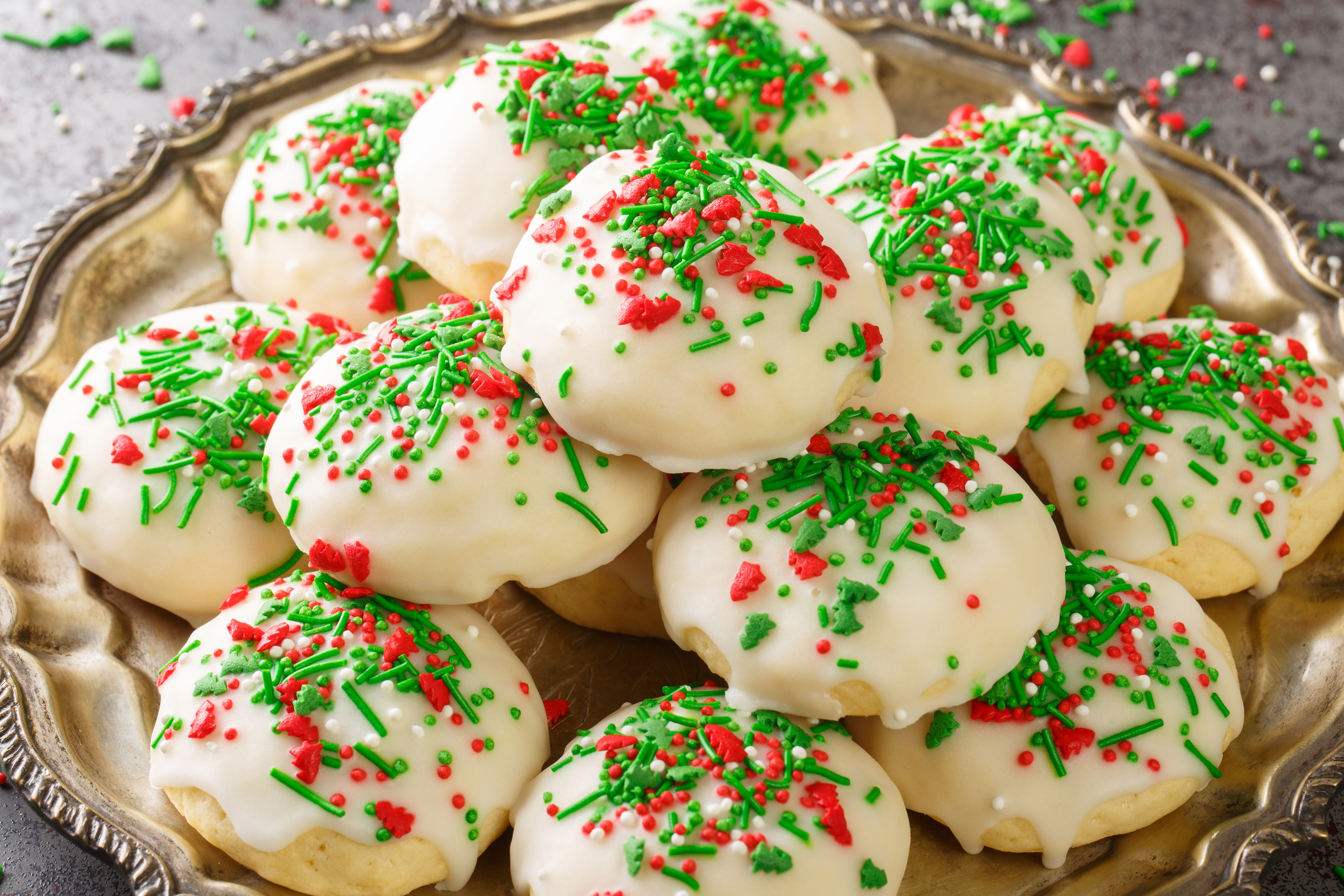 Plate of frosted cookies with red and green sprinkles, festive holiday treat