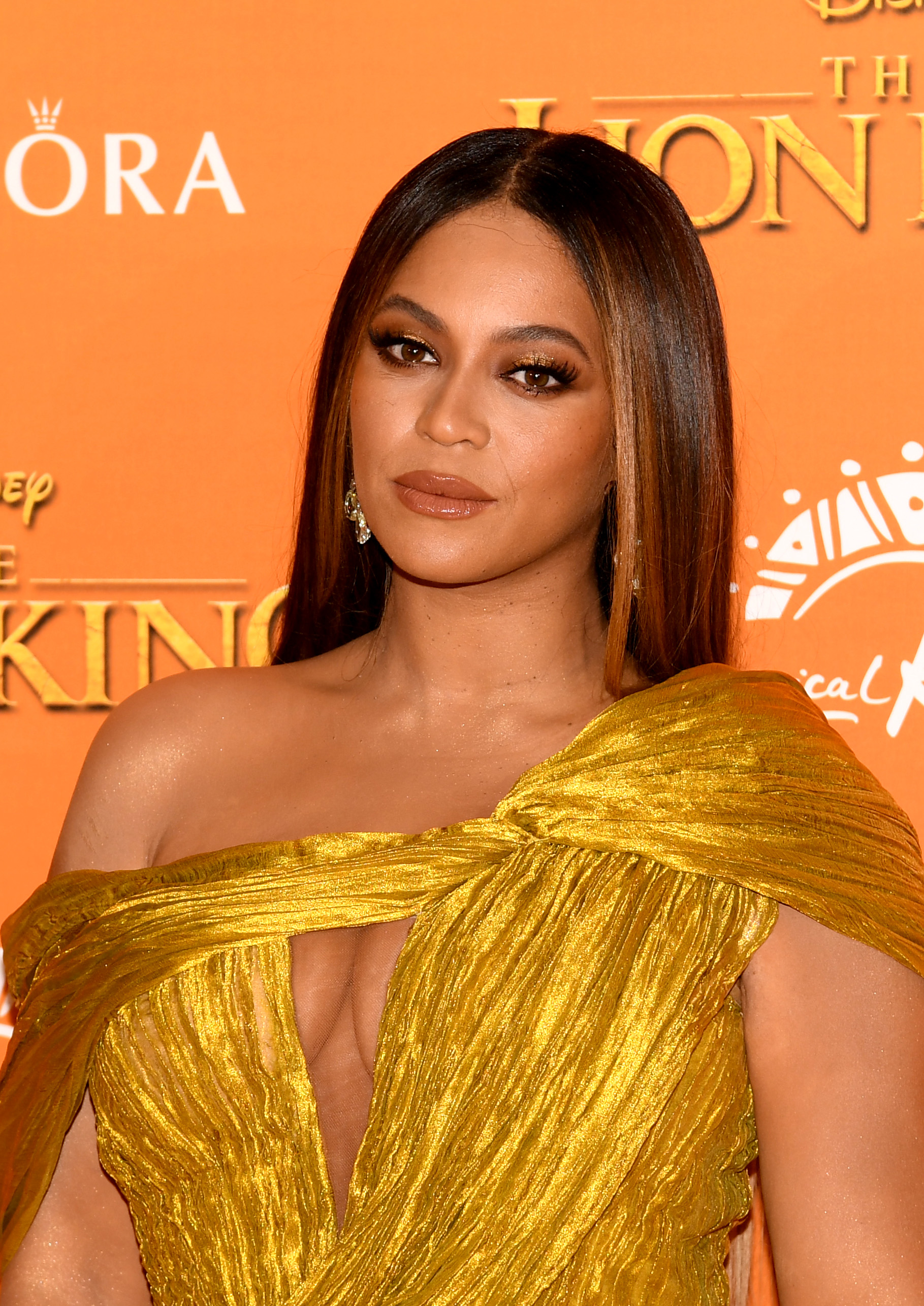 Beyoncé wearing a gold pleated off-the-shoulder gown at &#x27;The Lion King&#x27; premiere