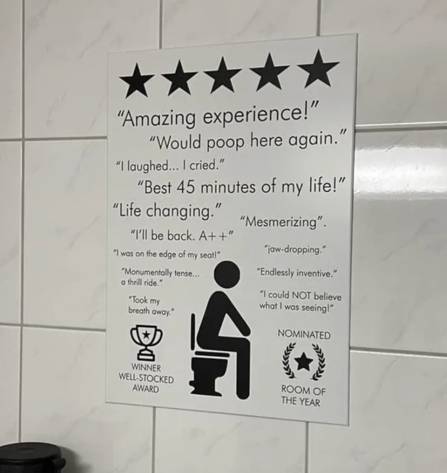 Humorous bathroom review sign with parody quotes and fictitious award symbols
