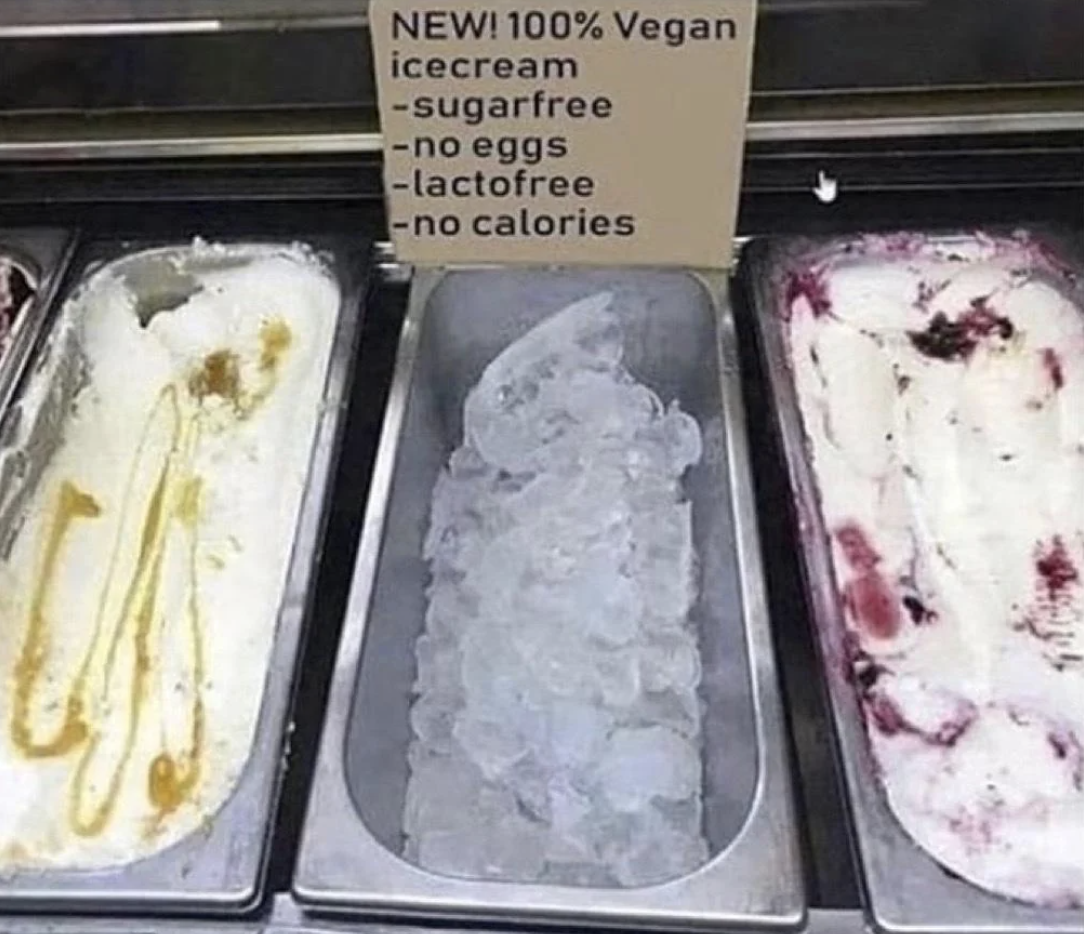 Three containers of vegan ice cream with a sign listing it as sugar-free, egg-free, lactose-free, and no calories