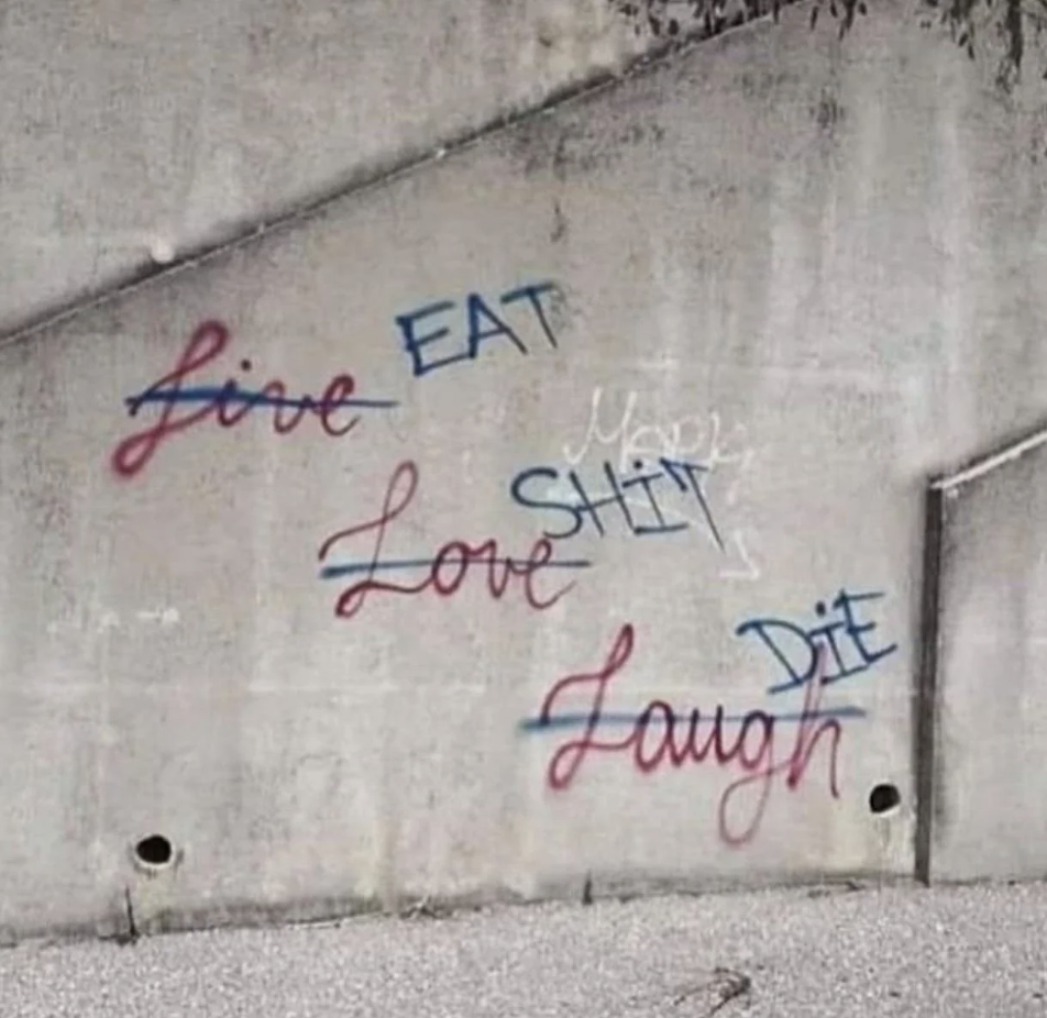 Graffiti on a wall parodying the phrase &quot;Live, Laugh, Love&quot; with additional negative words saying &quot;Eat Shit Die&quot;