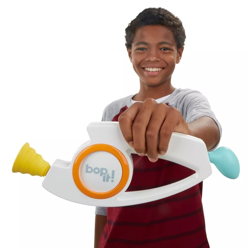 Smiling kid holding a Bop It! game