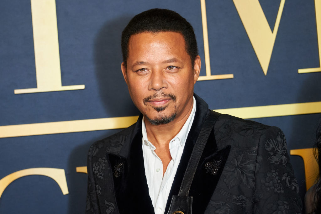 Terrence Howard in a black patterned jacket and shirt at an event