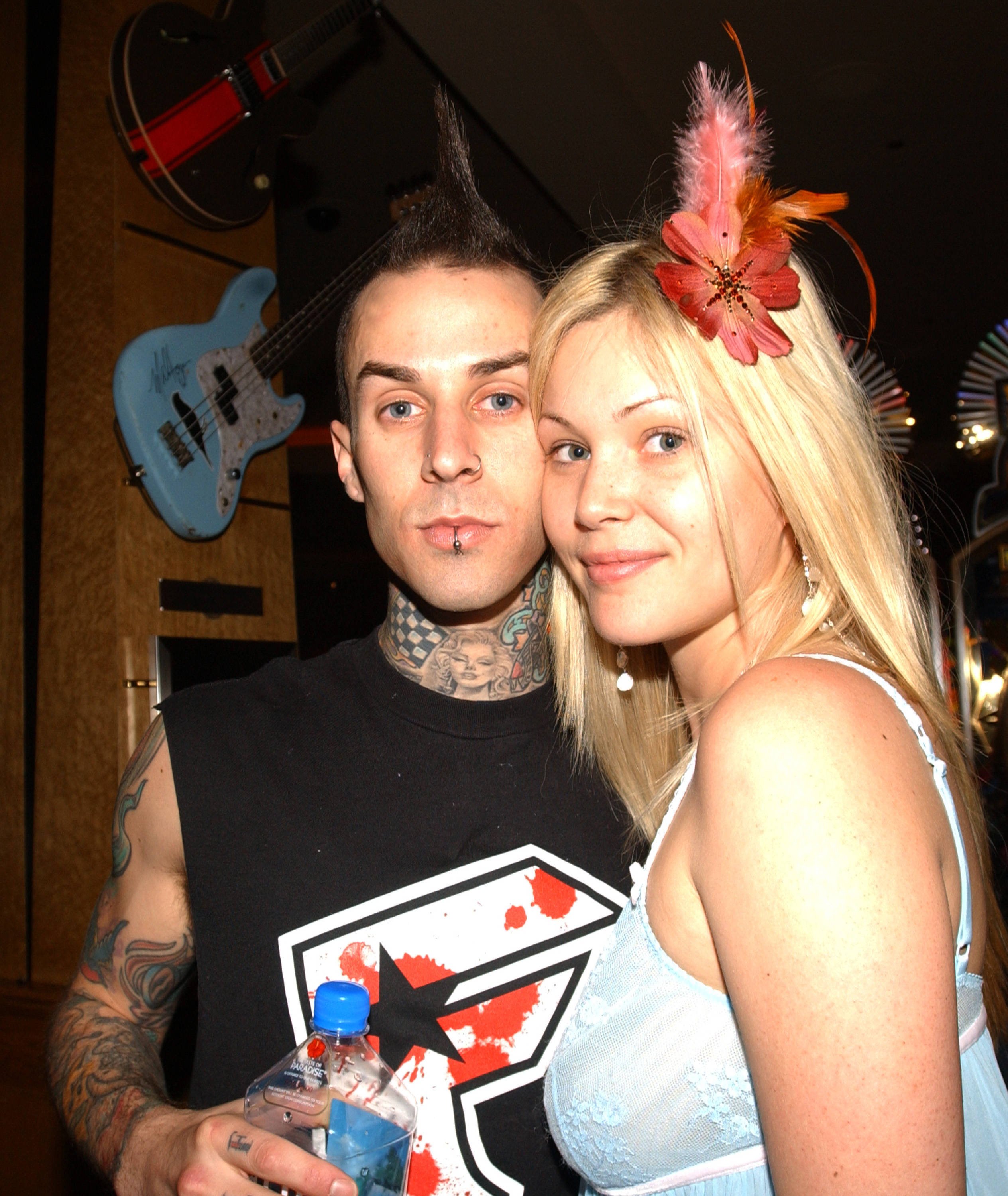 Travis, with spiked hair and tattoos, and Shanna with a feather accessory in her hair