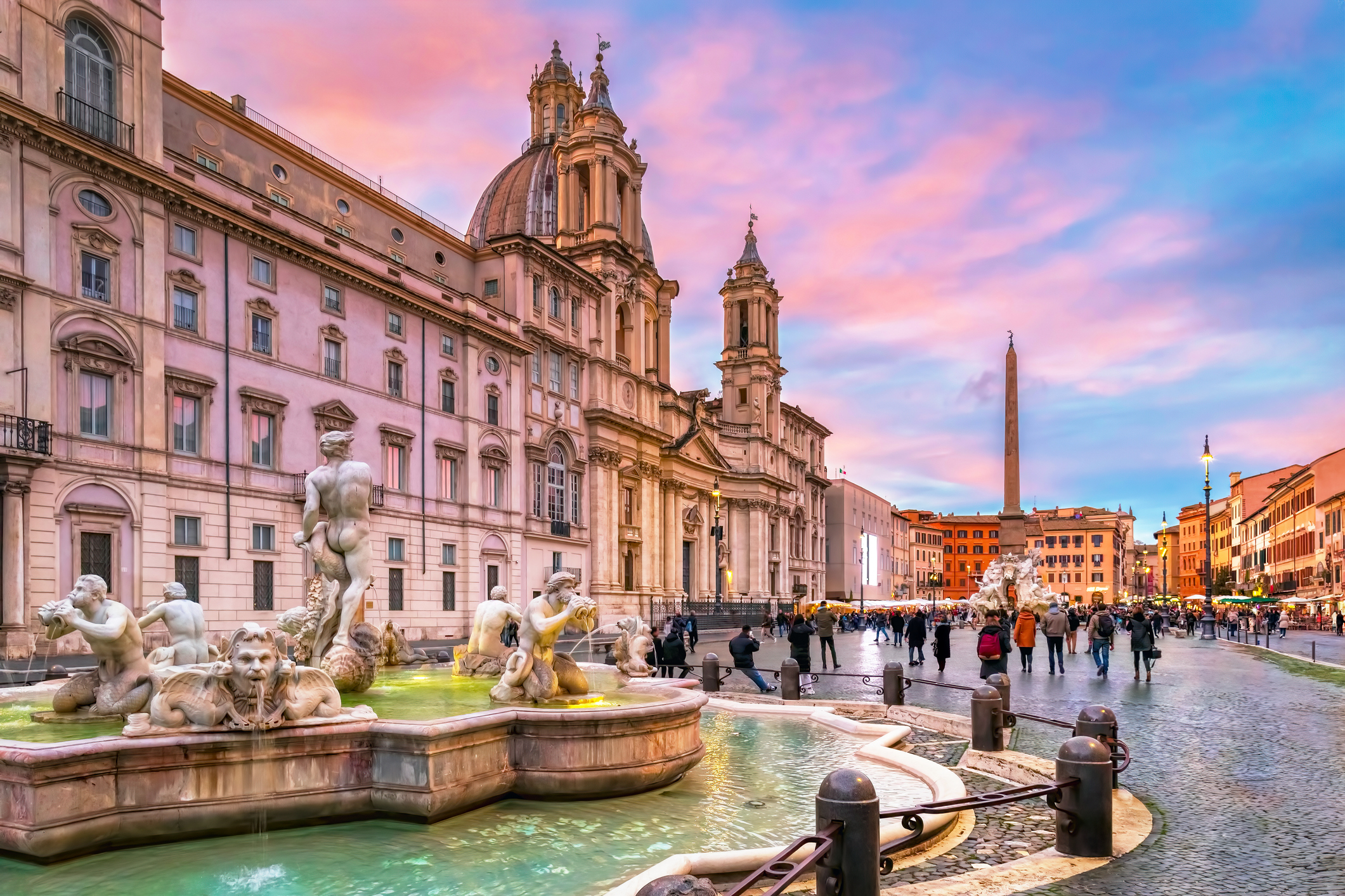 Piazza Navona in Rome with its fountains, ancient buildings, and visitors walking around