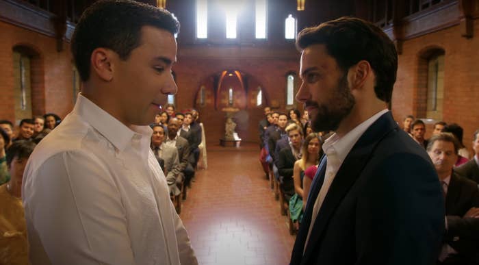 two man standing at the alter in front of friends and family