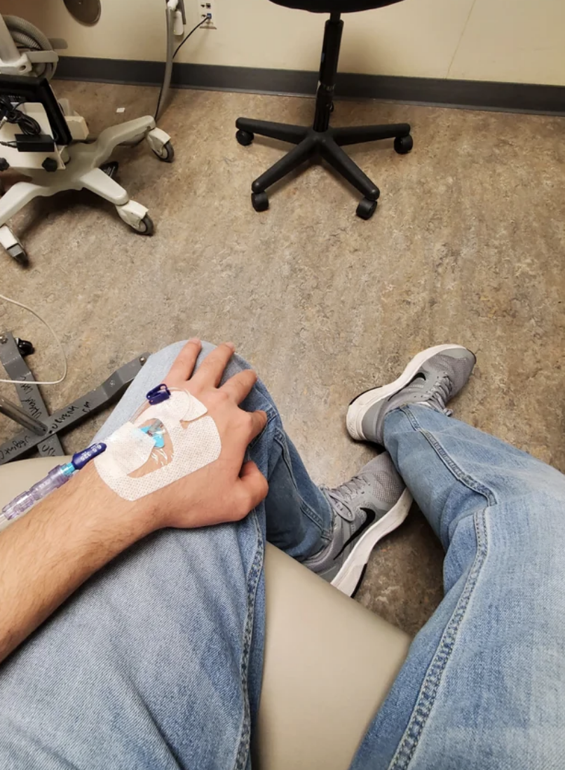 Person sitting with a medical patch on the knee and sneakers on