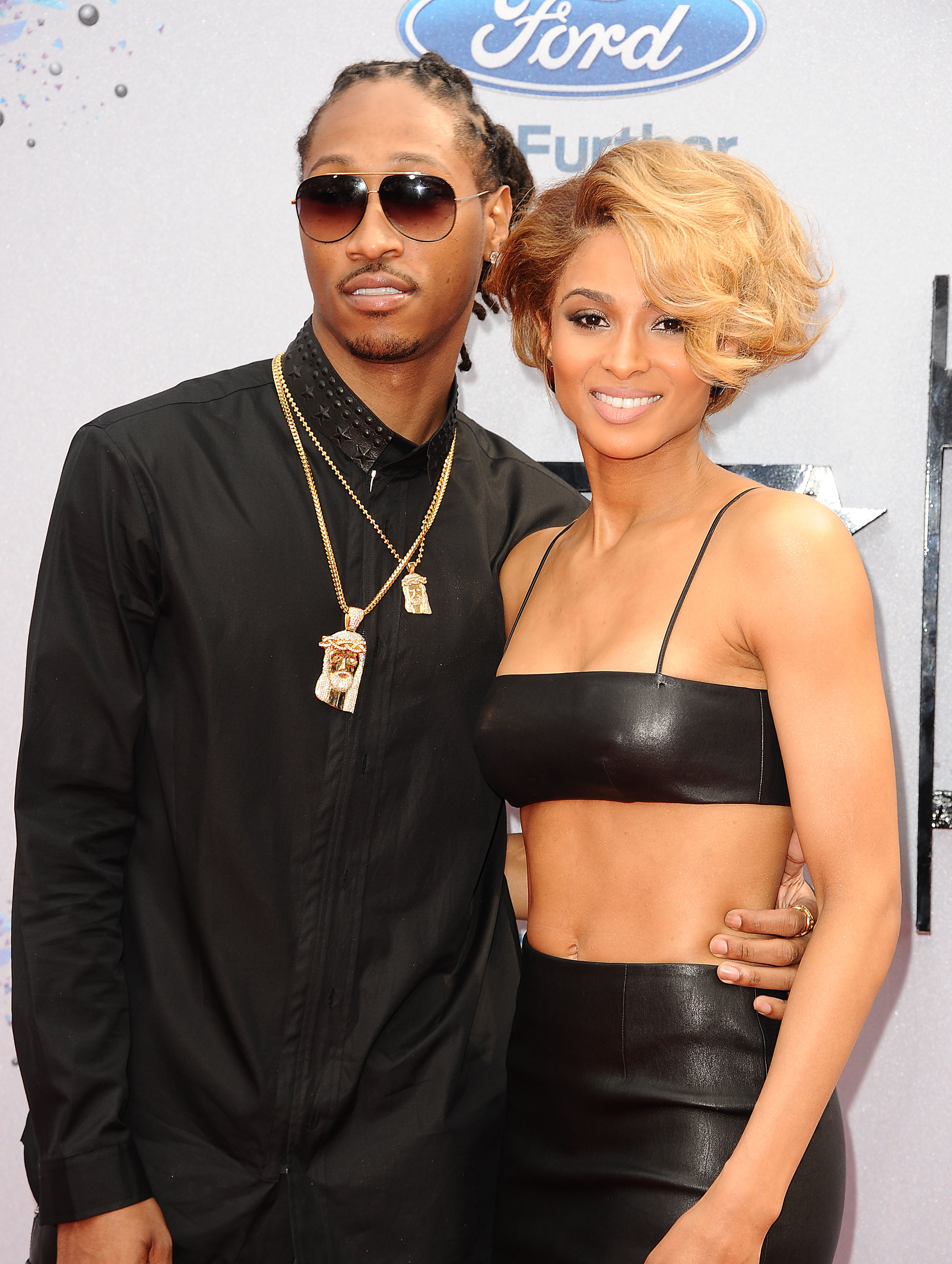 Future in a black shirt and sunglasses, and Ciara in a black crop top outfit