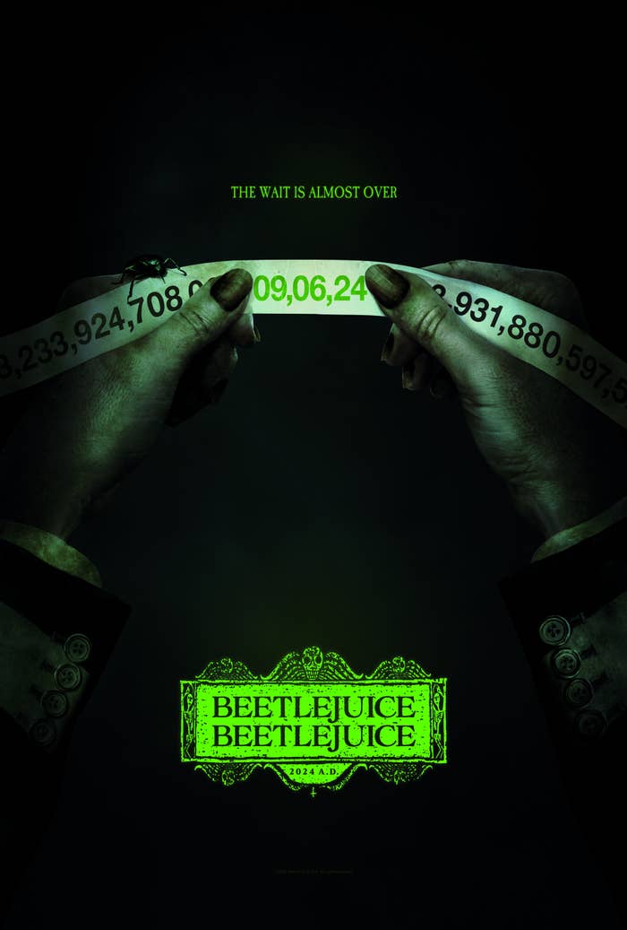 Movie poster for &quot;Beetlejuice Beetlejuice&quot; with hands holding a green-lit piece of paper and text about the wait being over