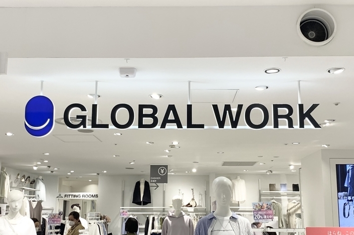 Storefront of GLOBAL WORK with mannequins wearing casual clothing and promotional banners