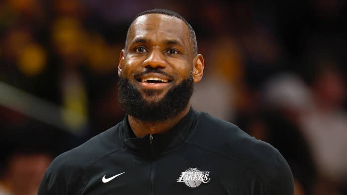 LeBron James smiling wearing a black Nike Lakers sweatshirt