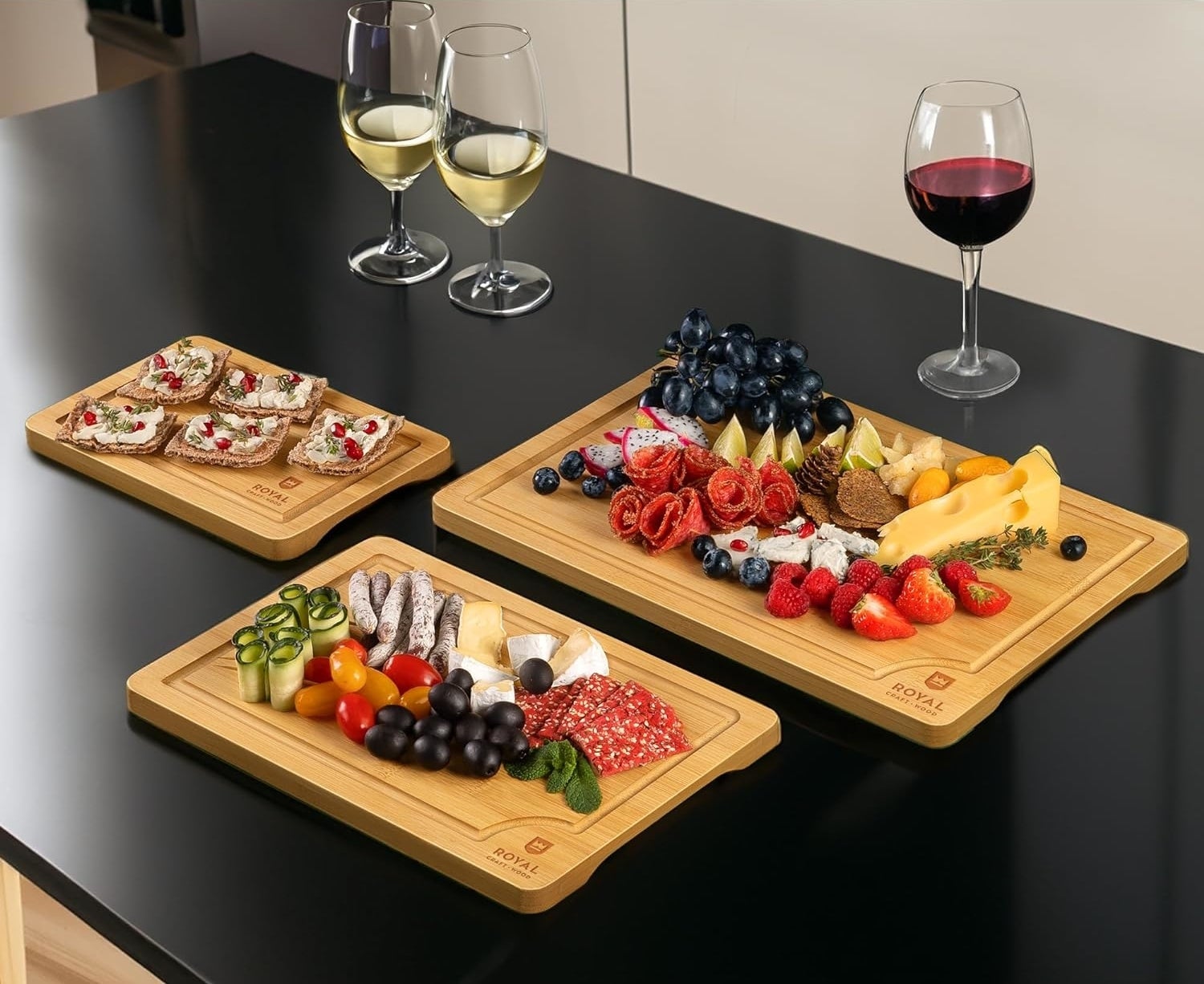 Assorted foods on three wooden serving trays for home entertaining
