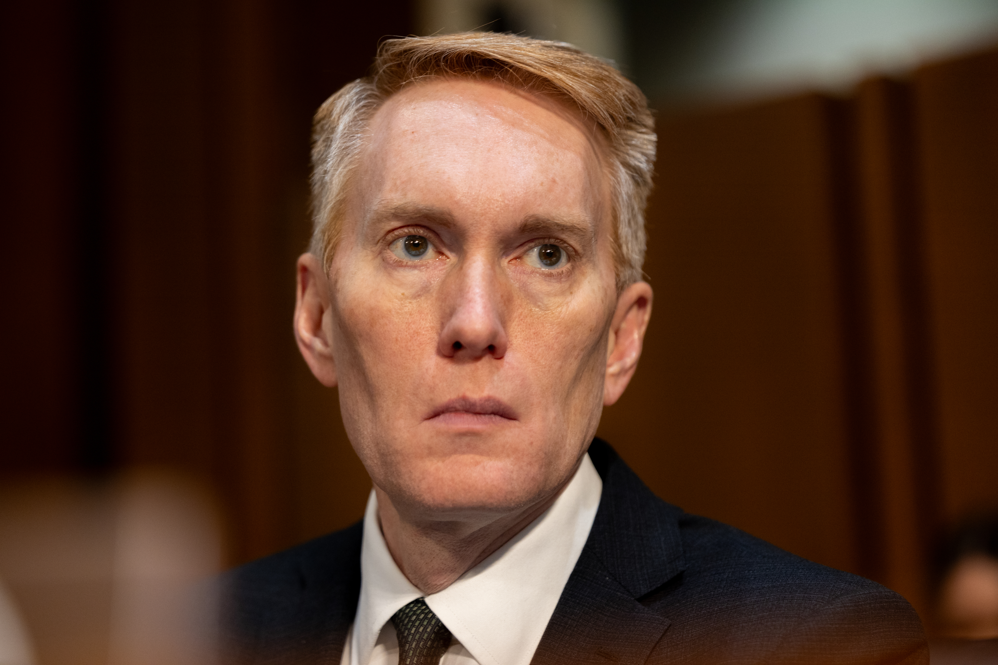Close-up of Lankford in a suit and tie, looking solemn