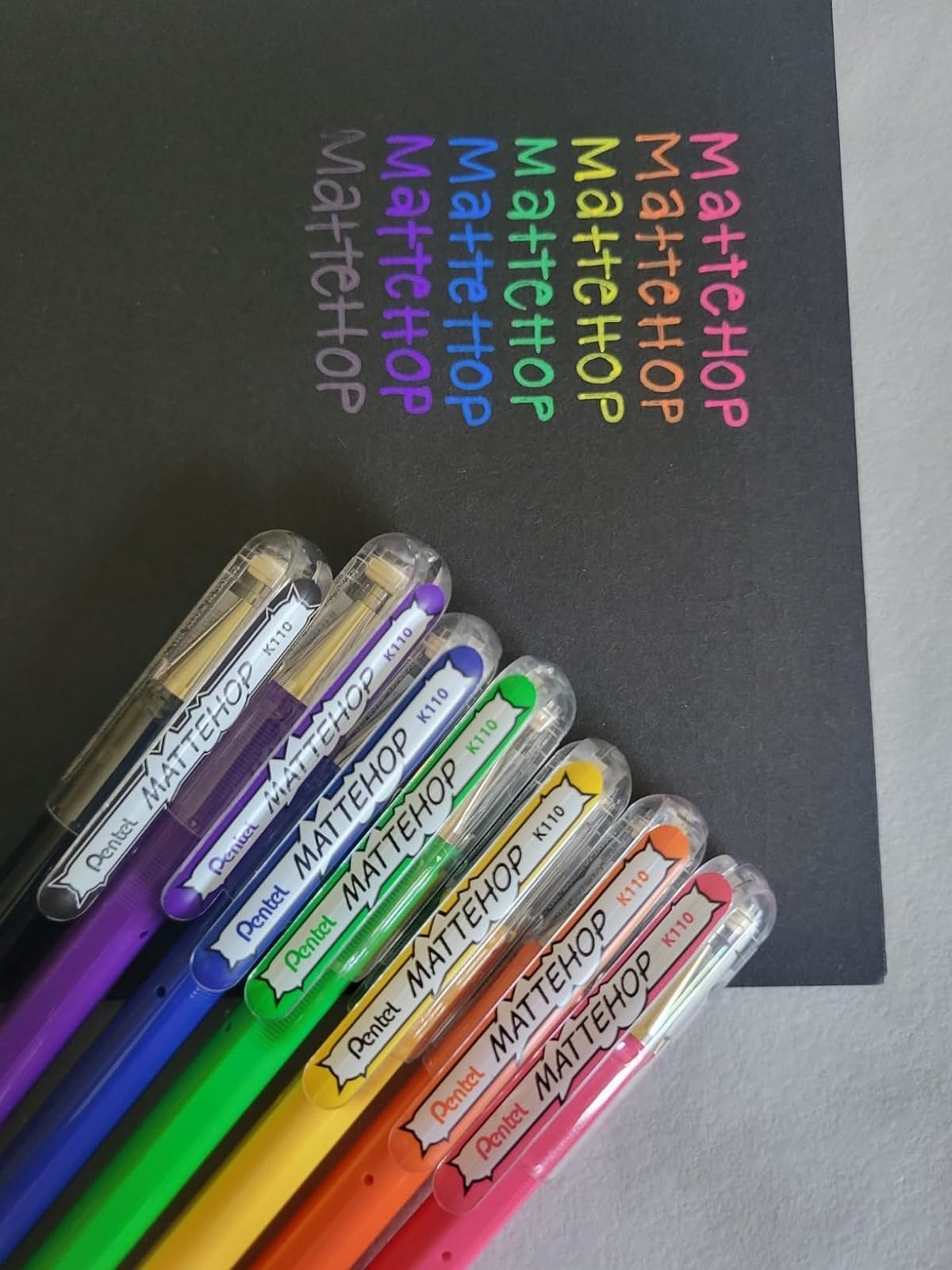 A set of vibrant MATTEHOP pens arrayed on a surface with their brand names visible