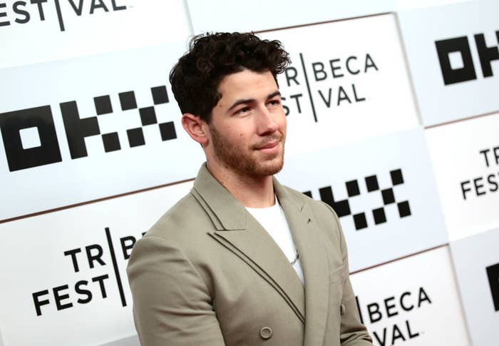 Nick Jonas in a tailored suit posing at the Tribeca Film Festival