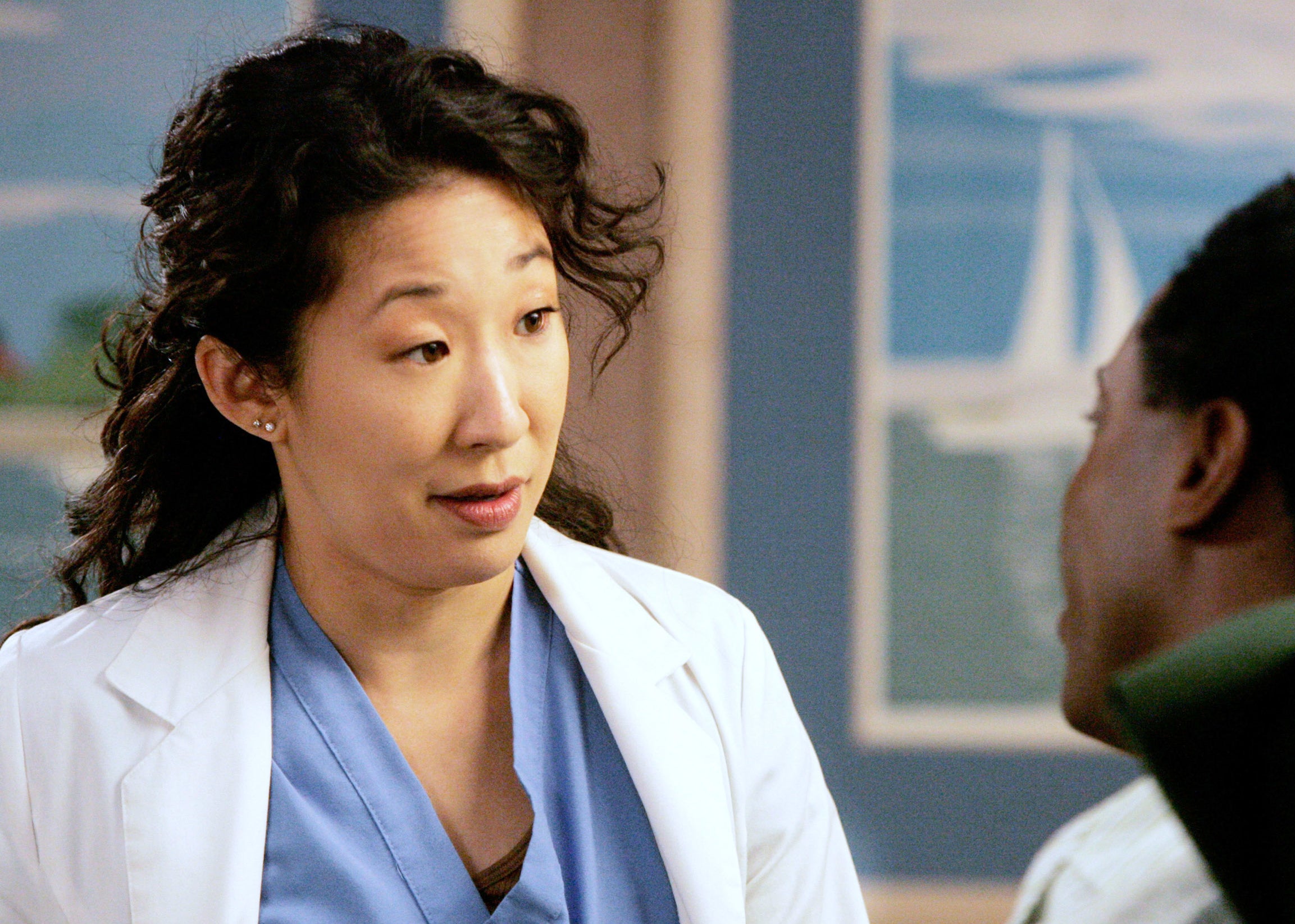 Two characters from Grey&#x27;s Anatomy, one wearing a lab coat, engage in conversation