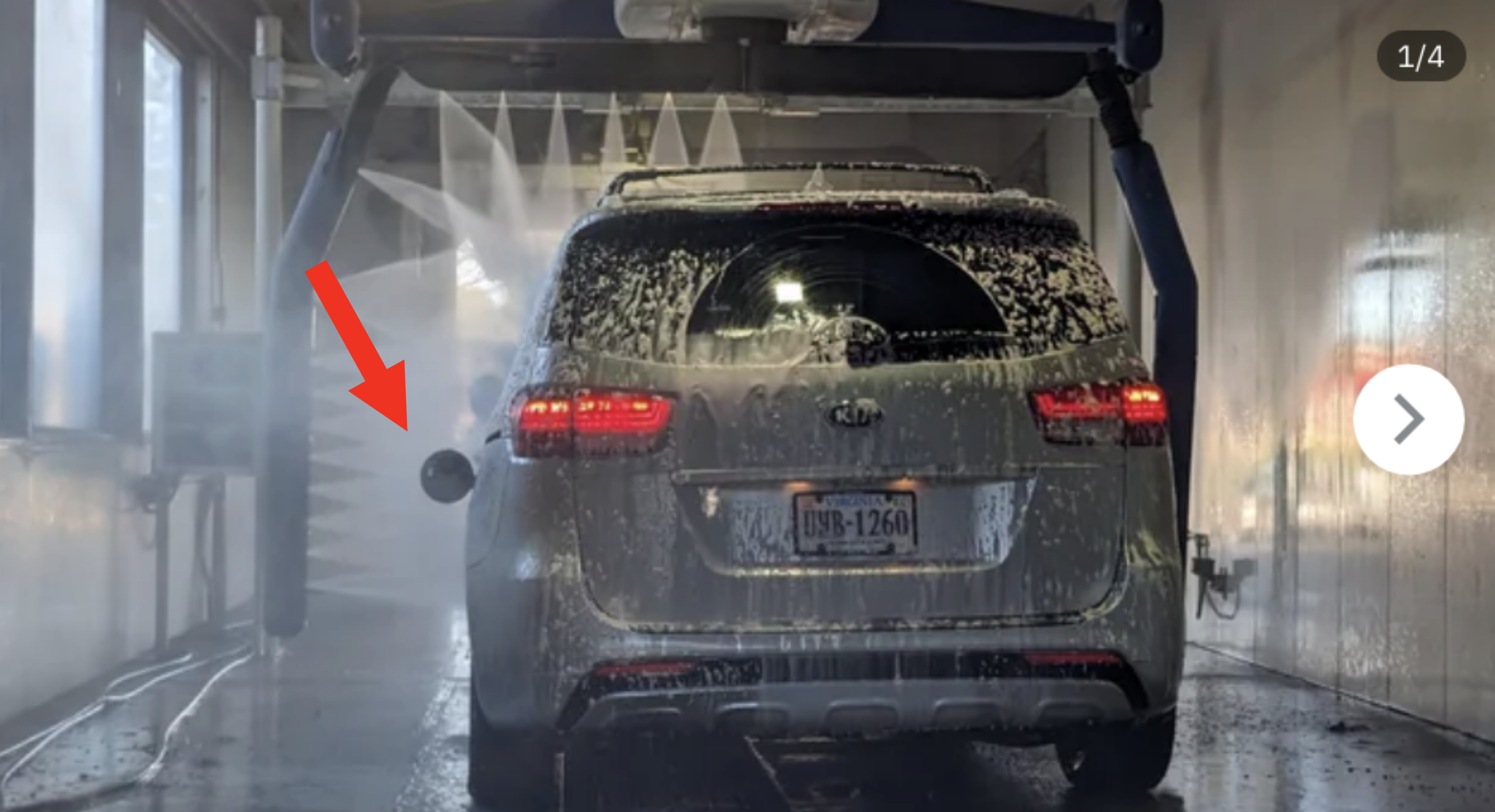 Car going through an automated car wash with water spraying on it