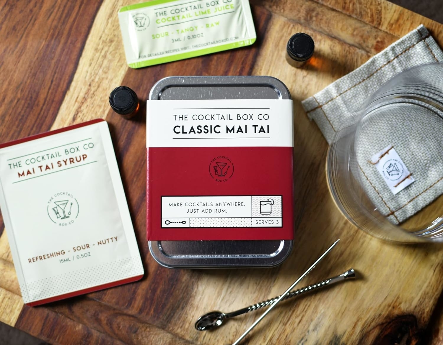 Classic Mai Tai cocktail kit with ingredients and tools displayed on a wooden surface