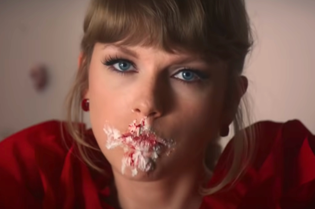 Taylor Swift with cake all over her face in the I Bet You Think About Me music video