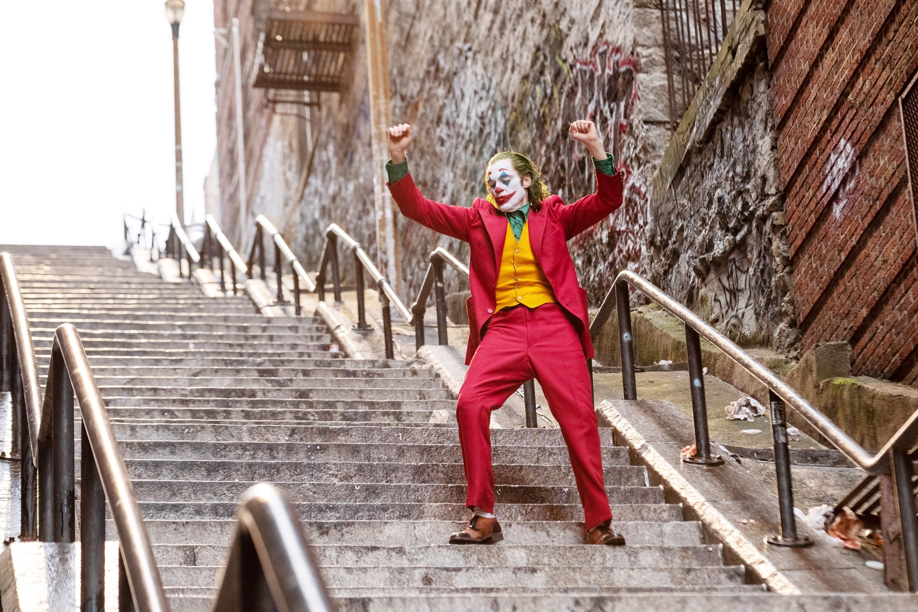 Joaquin Phoenix dressed as the Joker dancing on steps