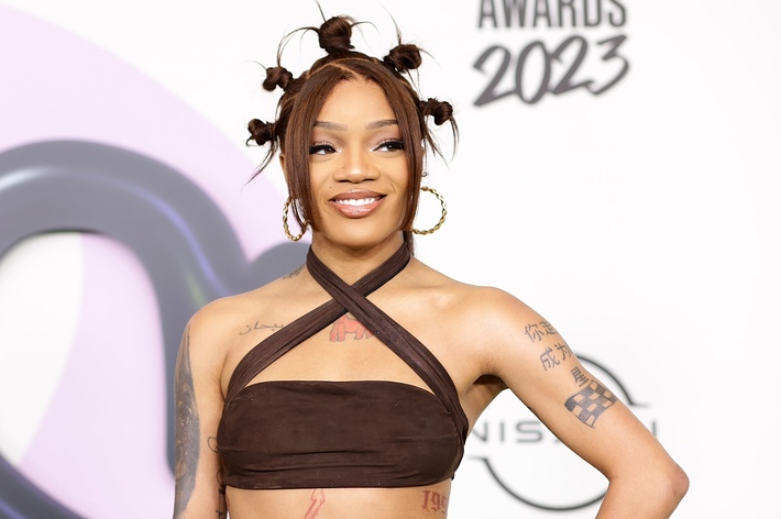 Woman with twisted updo hairstyle wearing a strapless top at the 2023 Awards event