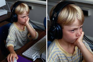 Young child with headphones at a computer, looking pensive and touching their cheek