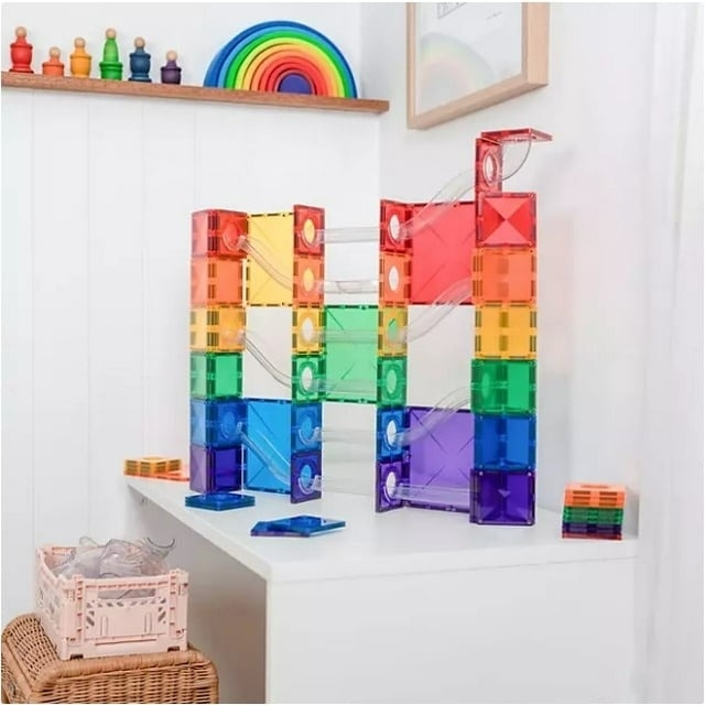 A colorful magnetic tile construction set displayed on a white shelf, showcasing a creative design. Suitable for educational play