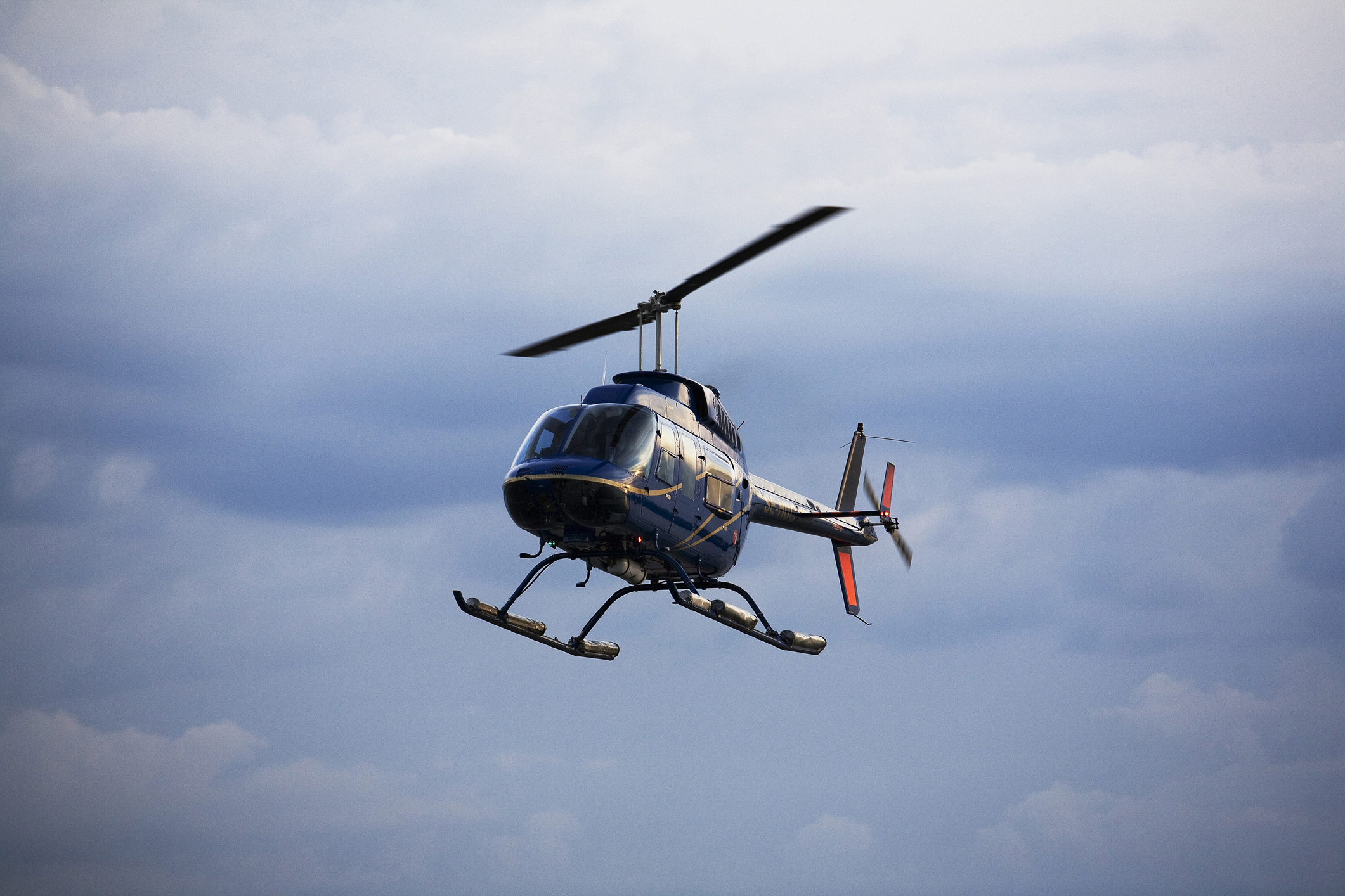 Helicopter in flight against a cloudy sky