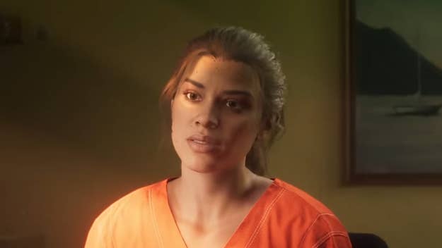 Woman in orange outfit, looking forward, with a concerned expression in a dimly lit room
