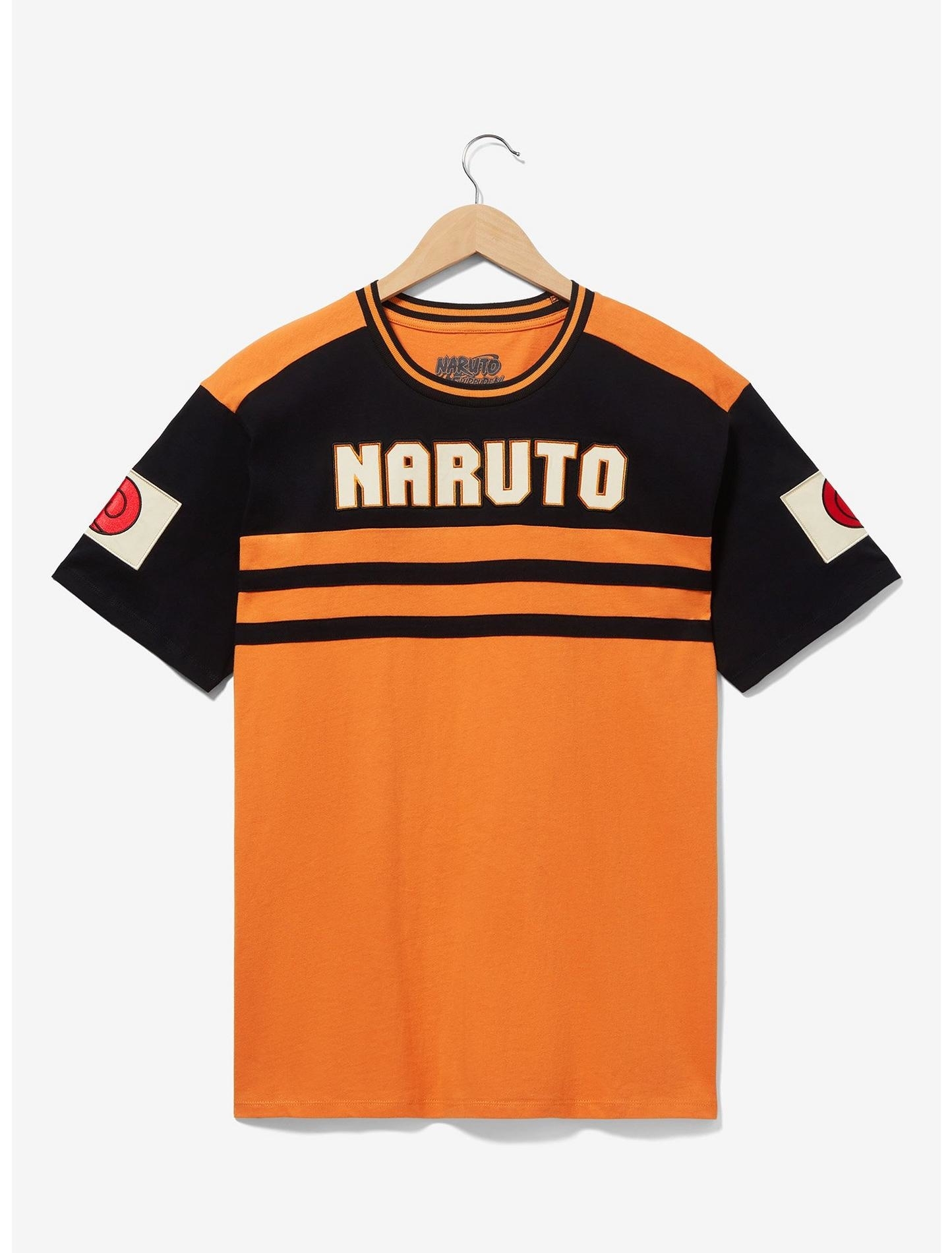 Graphic tee with &quot;NARUTO&quot; text, hanging against a plain background, inspired by the anime