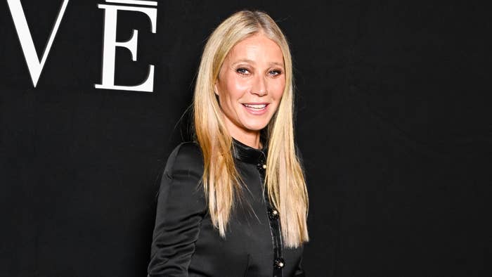 Gwyneth Paltrow in a sleek black outfit with a simple design, attending an event