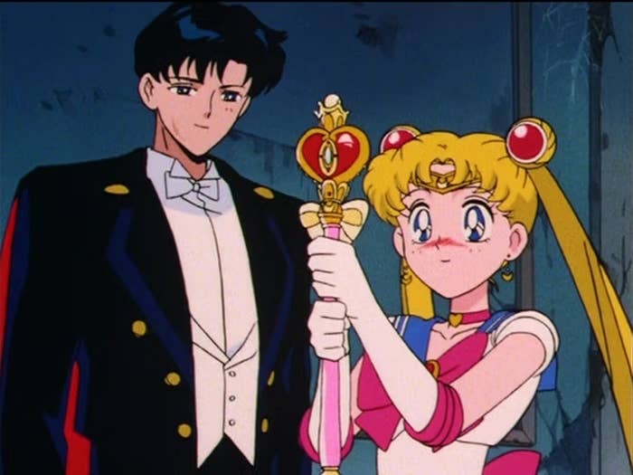 Tuxedo Mask and Sailor Moon from the anime Sailor Moon, standing side by side with a friendly pose