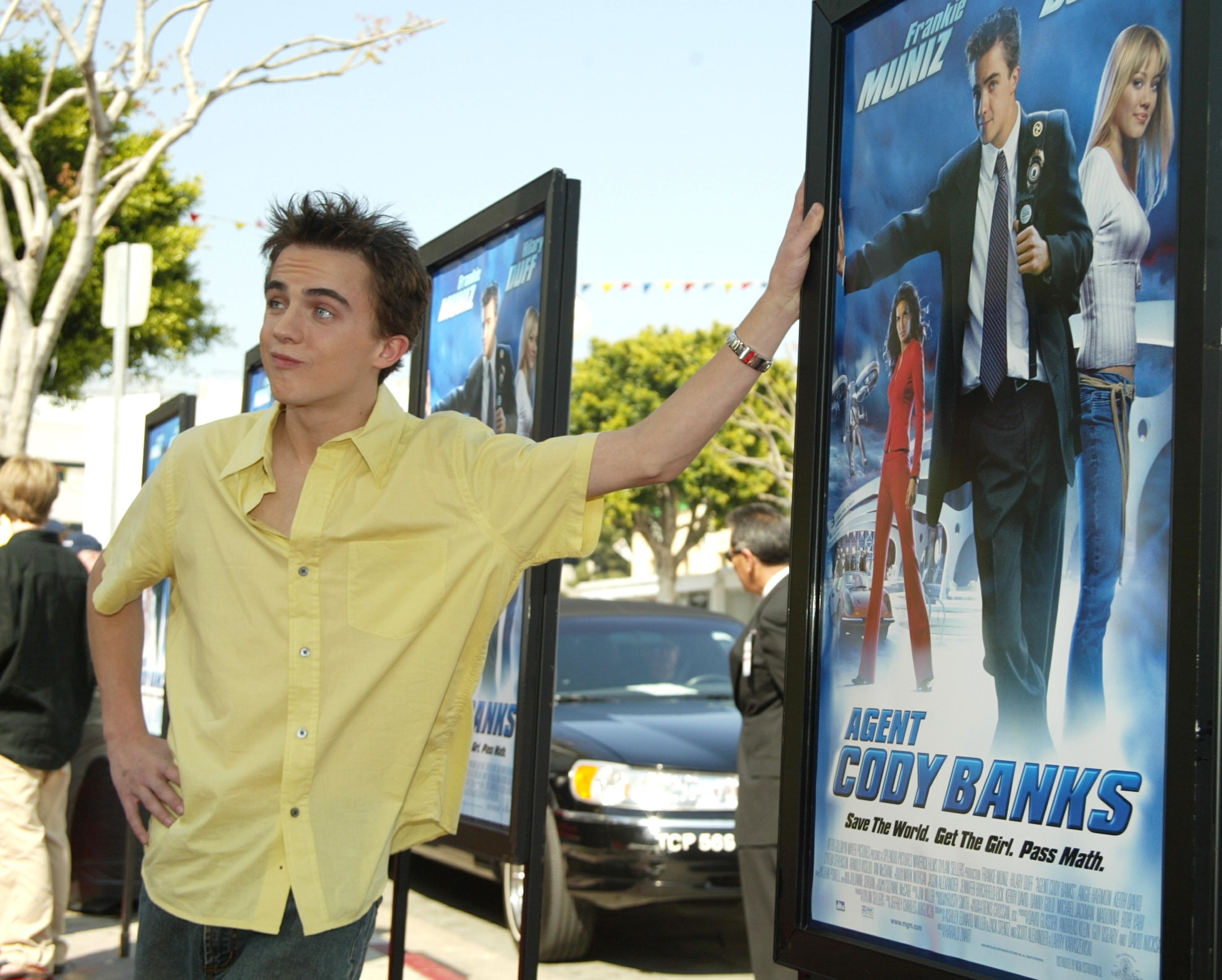 Frankie Muniz standing next to &quot;Agent Cody Banks&quot; movie posters at a promotional event