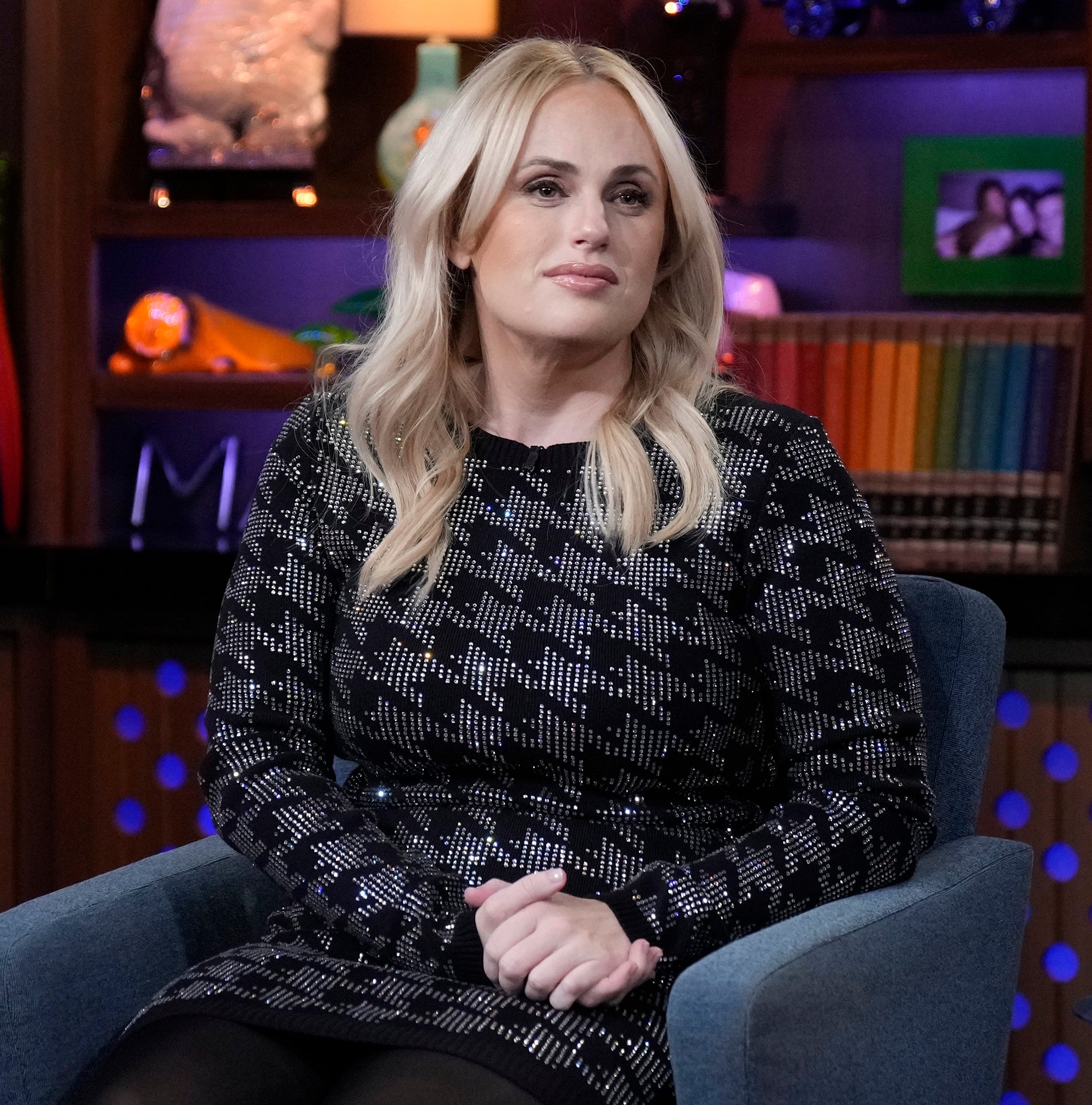 Rebel in a patterned dress sitting on a talk show set