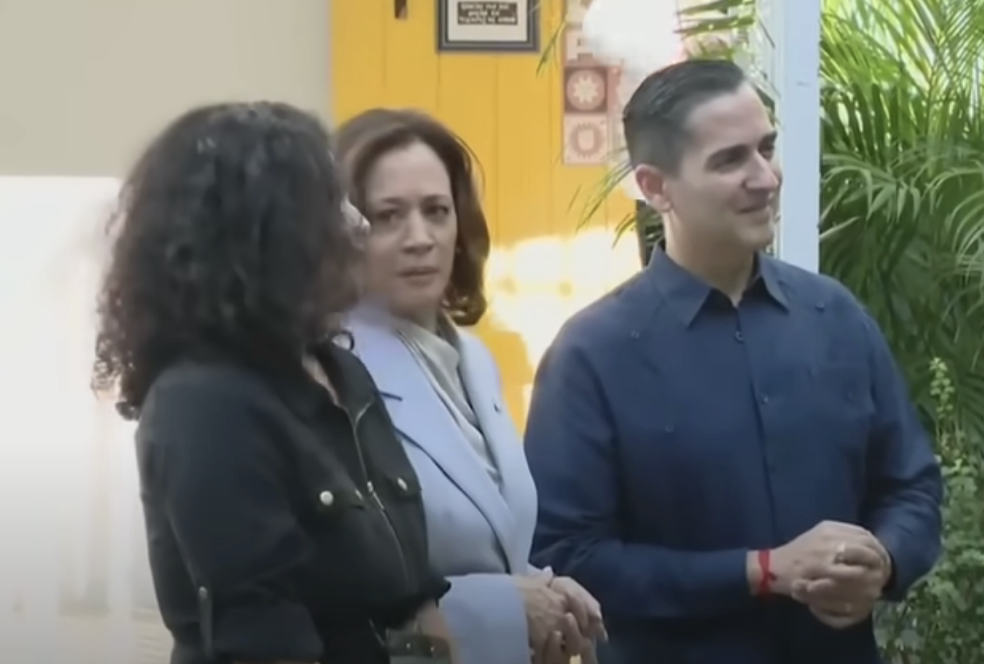 Kamala looking at the executive director, with her hands clasped