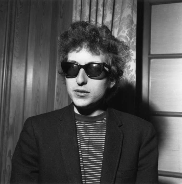 Bob with sunglasses wearing striped shirt and jacket