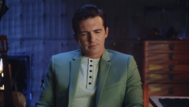 Drake Bell in Quiet on Set looking down